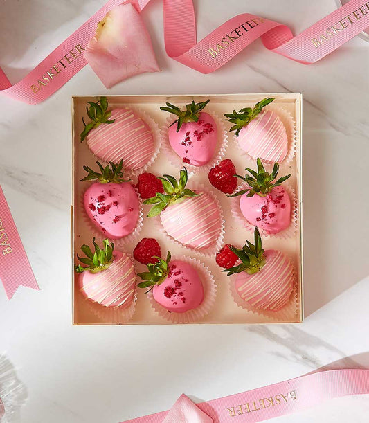 Pink strawberry chocolate delights, nine artisan-dipped pieces with white drizzle, fresh raspberries, premium gift box addon