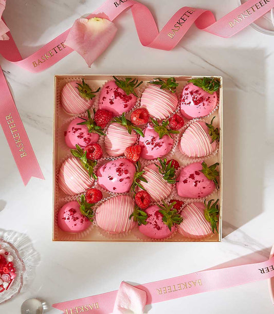 Deluxe pink and dark pink chocolate-covered strawberries with raspberries in luxury gift box