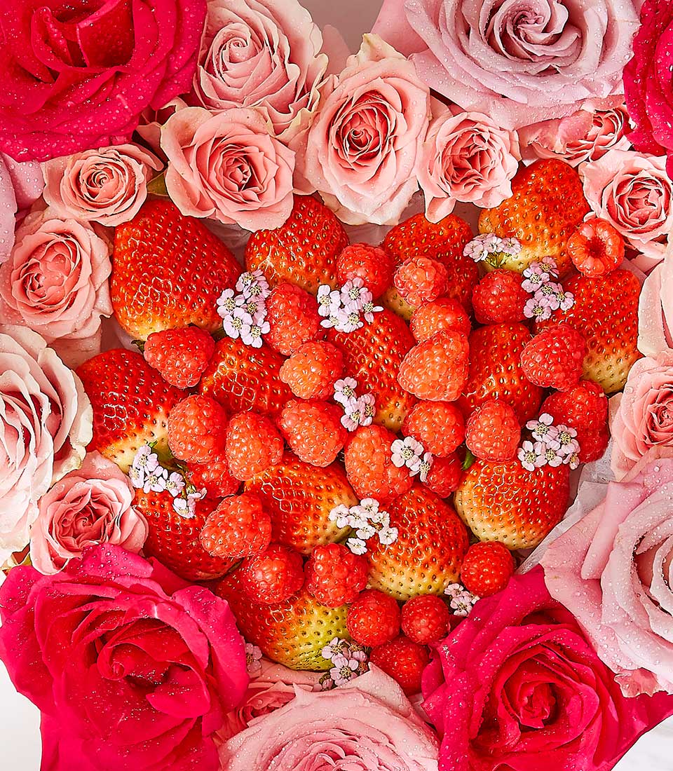 Heart-shaped strawberry and rose arrangement with fresh berries and pink roses for birthdays