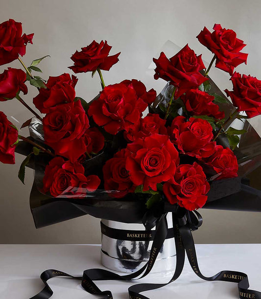 Luxurious red roses bouquet in silver container with black satin ribbon, perfect anniversary gift for her