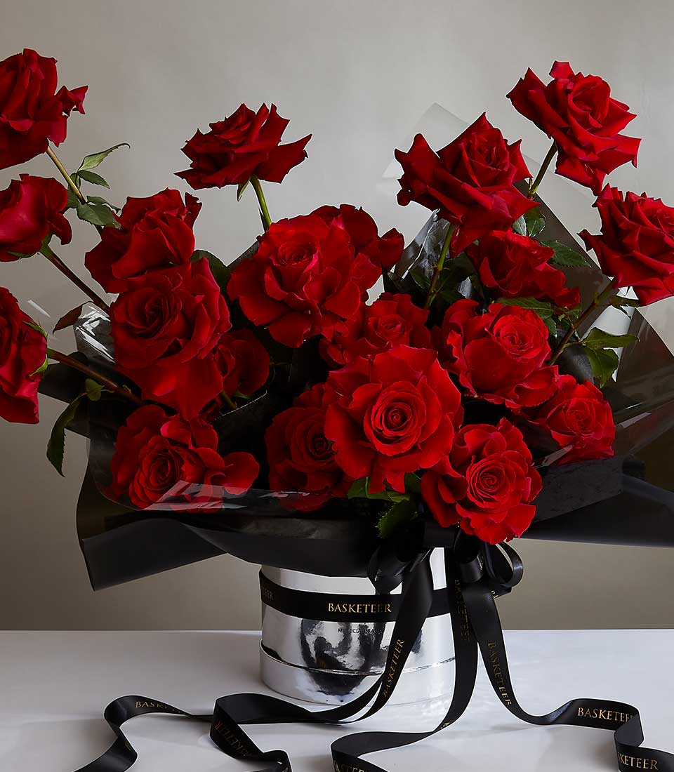 Luxurious red rose bouquet in silver container with black ribbon for anniversary and romantic gifts