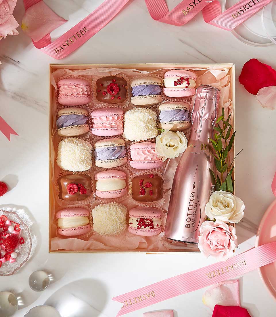 Rose gold Bottega sparkling wine with pastel macarons and fresh roses Valentine gift set