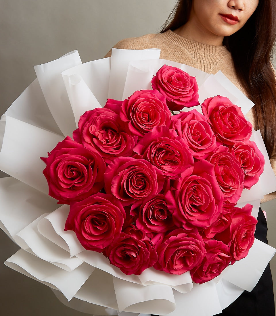 Pink roses bouquet in white paper wrapping, luxury anniversary gift for her
