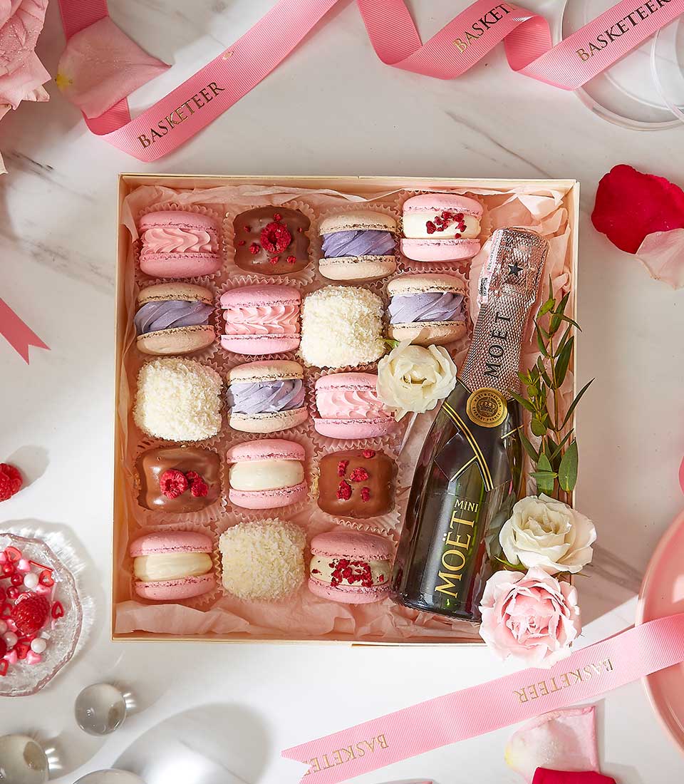 Luxury wooden gift box with assorted macarons, mini Moët champagne, and fresh roses for Valentine's Day