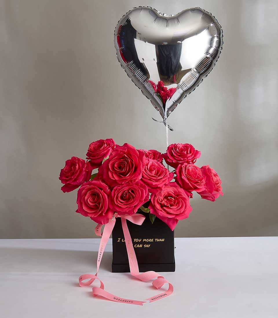 Romantic pink rose bouquet in black box with heart balloon and I Love You message for Valentine's Day
