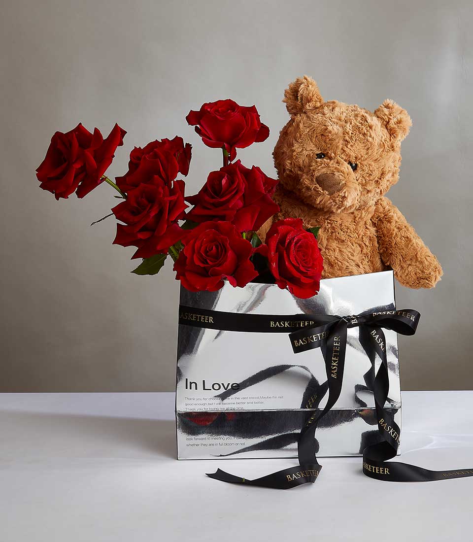 Red roses with brown teddy bear in silver gift bag, romantic birthday present for her