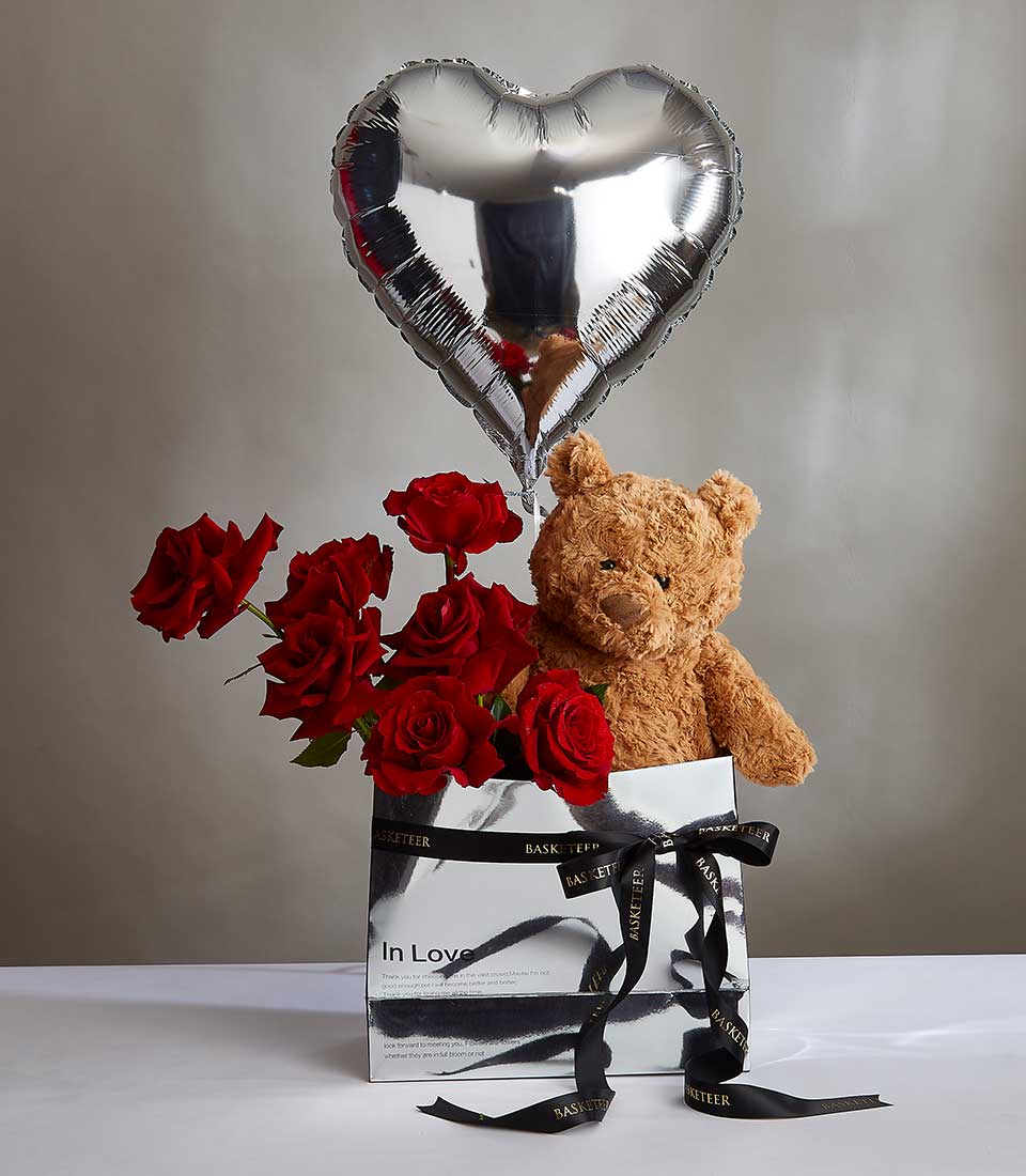 Red roses with teddy bear and heart balloon in luxury Valentine's gift box