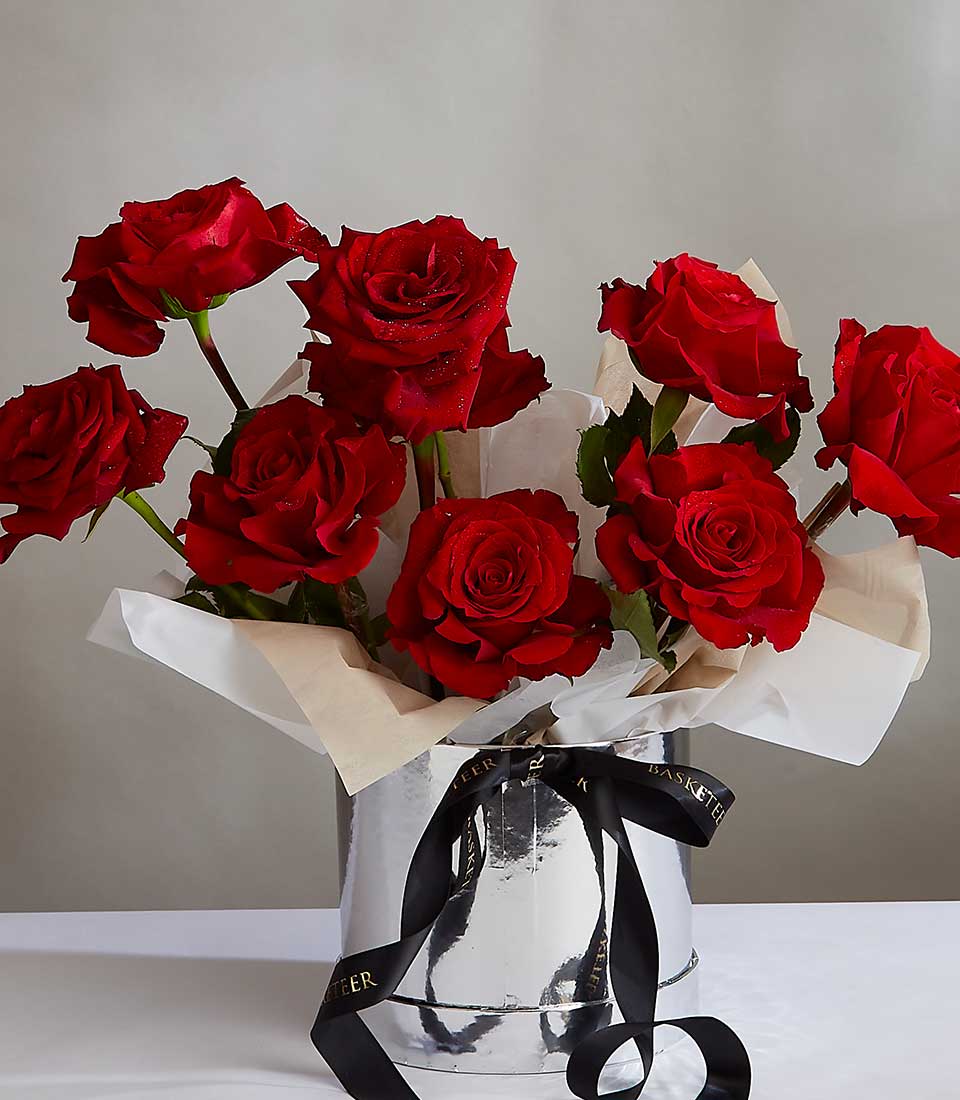 Deep crimson roses in silver cylinder with black satin ribbon, fresh Ecuador blooms for anniversary celebrations