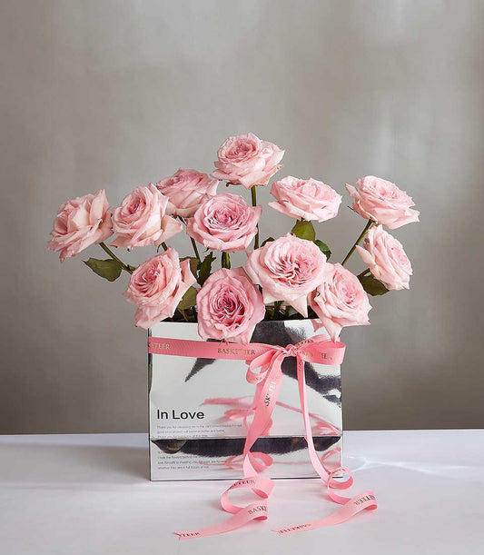 Light pink roses in silver gift box with pink ribbon bow, luxury birthday flowers for her