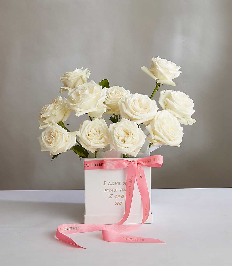 Ivory Bloom white roses in luxury gift box with pink ribbon and gold sentiment message
