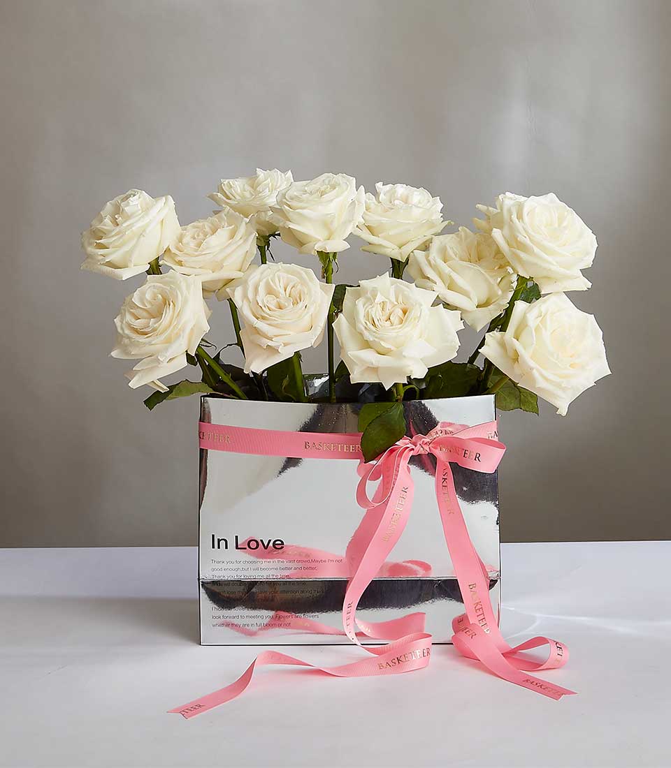 White rose bouquet with pink ribbon in silver gift box, fresh Ecuadorian roses for birthday celebrations