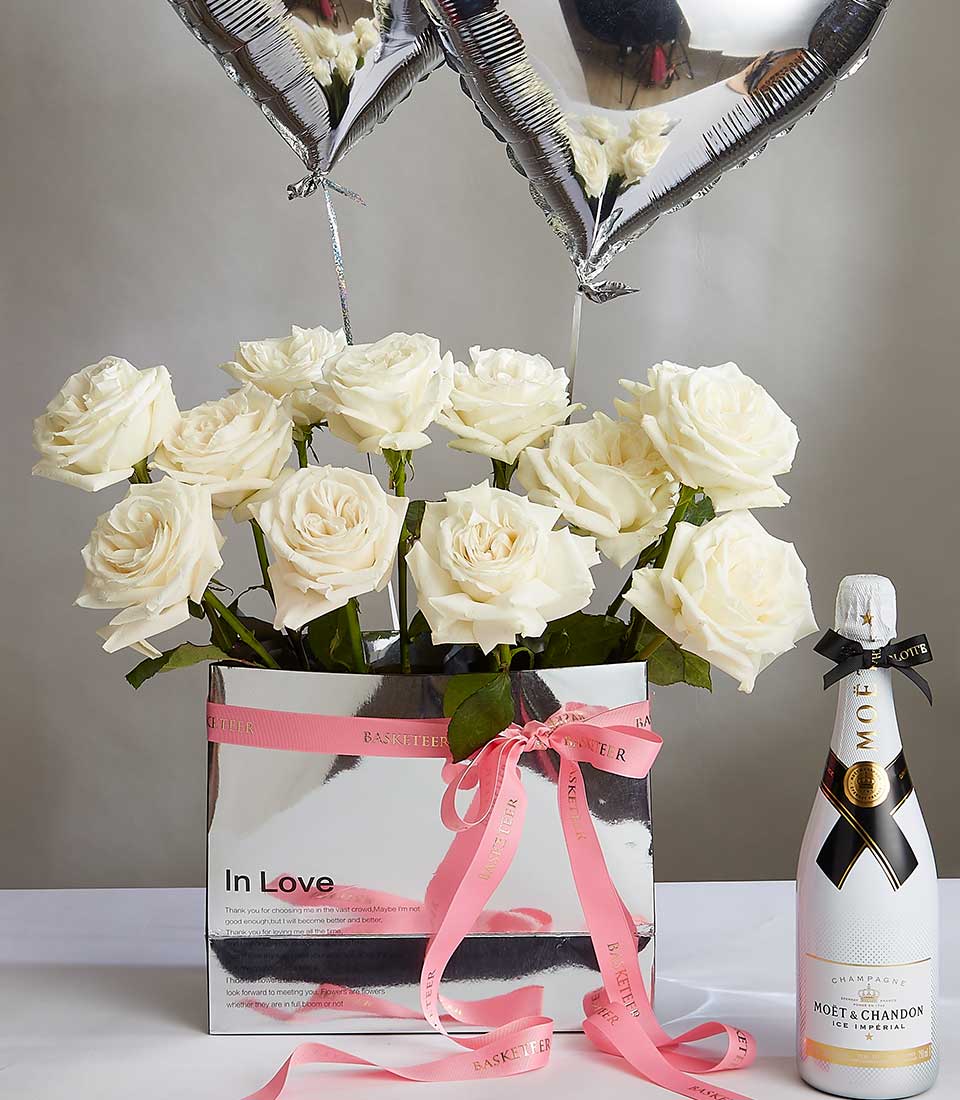 Luxury Valentine's gift set with white Playa Blanca roses, Moët & Chandon champagne, and heart balloons in silver box