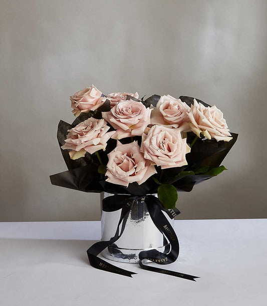 Light pink rose bouquet in silver vase with black ribbon for anniversary gifts