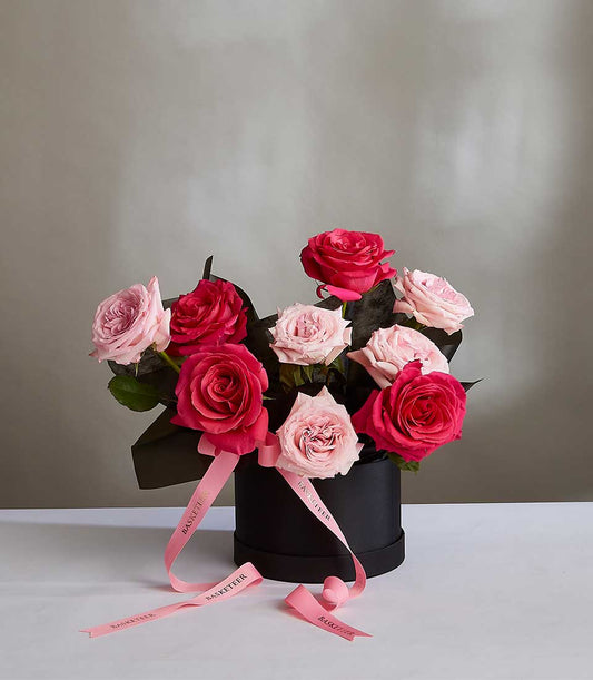 Midnight Pink Rose Bouquet in black hatbox with deep and light pink roses, tied with pink ribbon