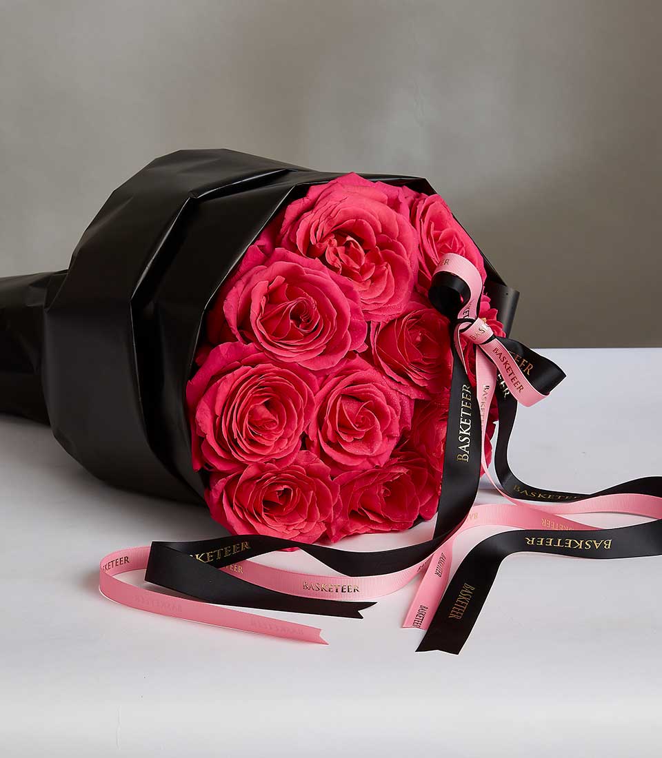 Pink Floyd roses bouquet wrapped in black paper with gold and pink ribbons for anniversaries