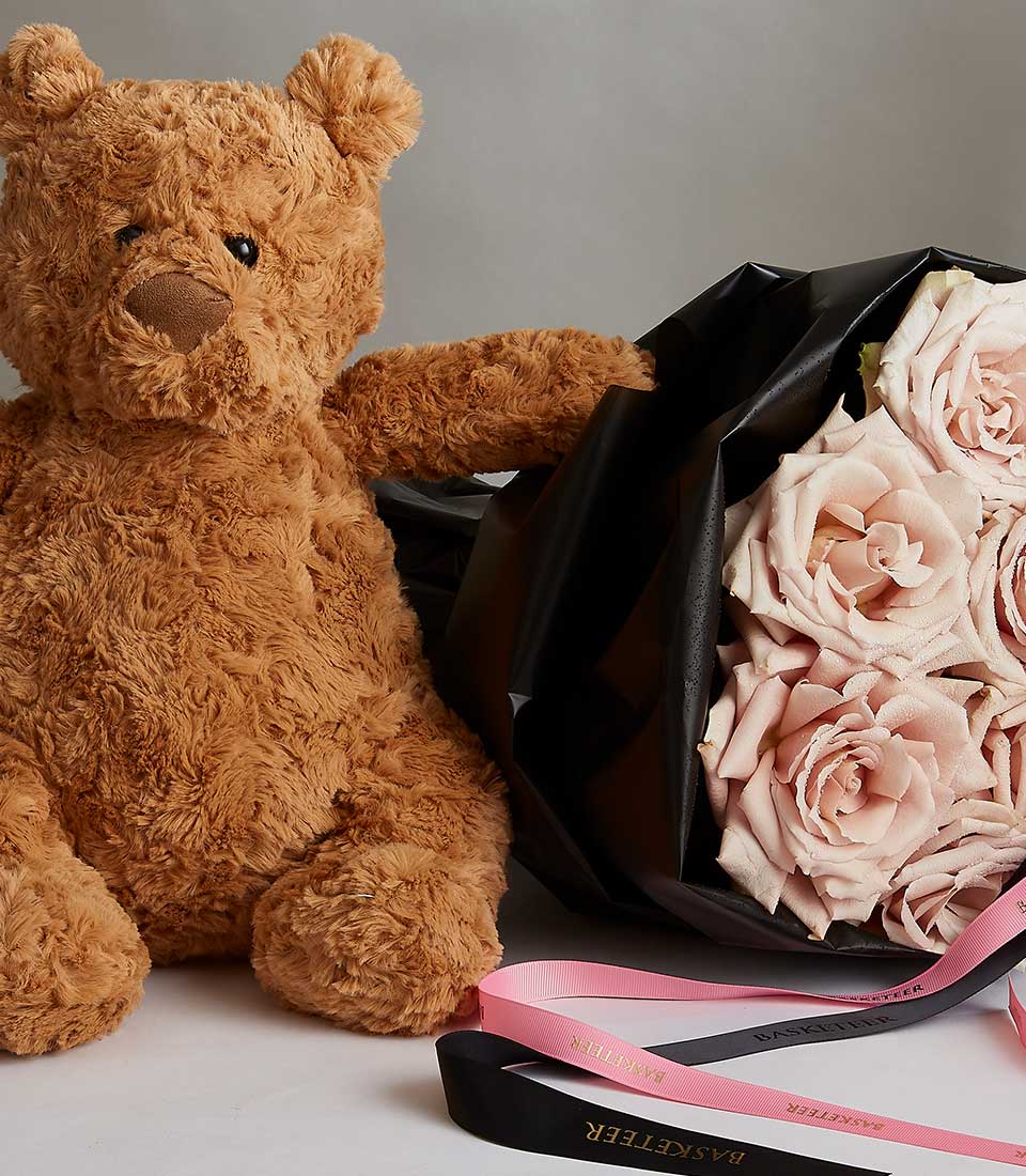 Light pink rose bouquet with teddy bear and black ribbon for Valentine's Day