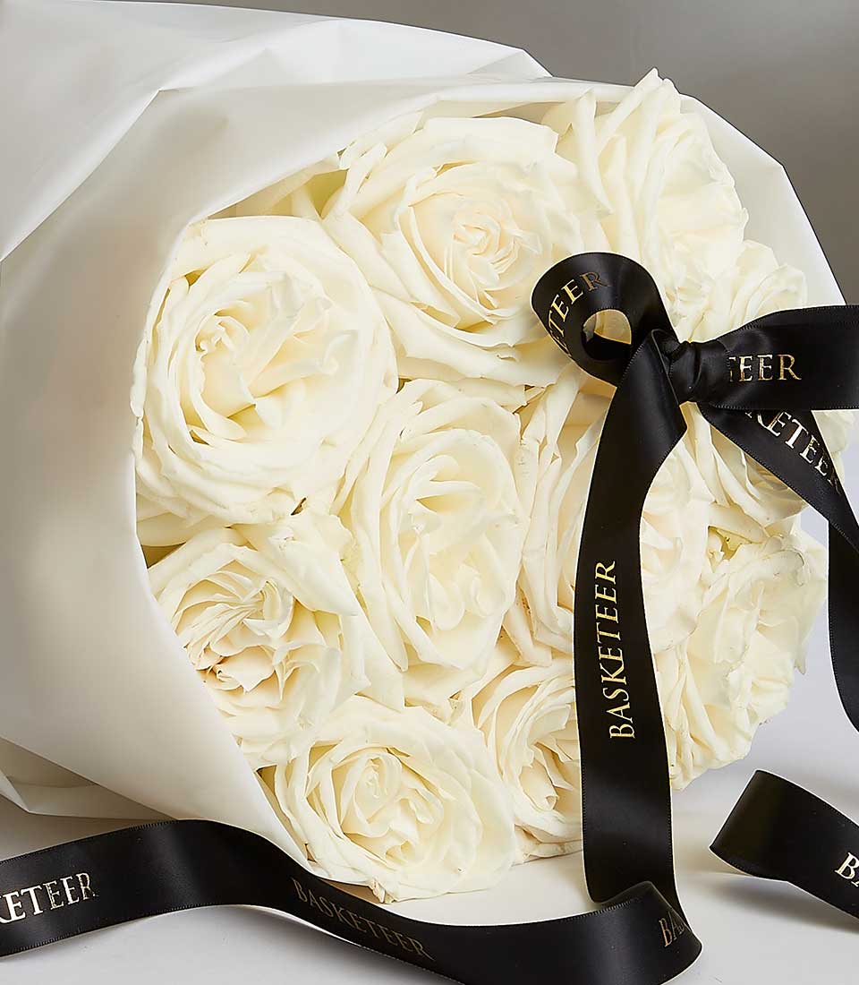 Fresh white Playa Blanca roses luxury bouquet with cream wrapping and branded ribbon, ideal birthday gift for her