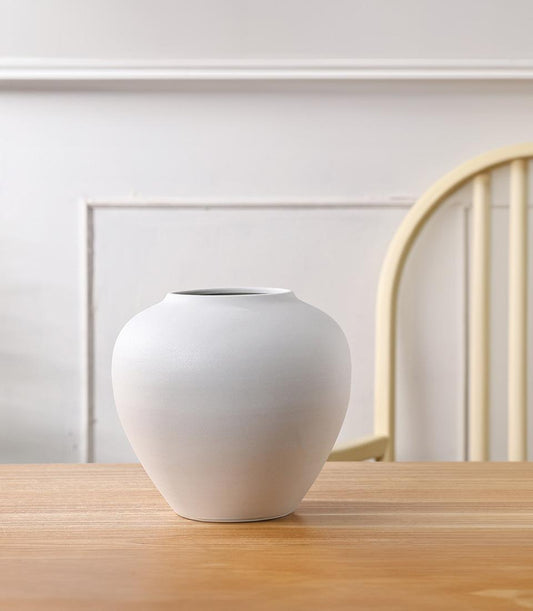 Minimalist white ceramic vase with matte finish and rounded bulbous body for home decor