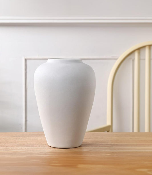 Minimalist white ceramic vase with matte finish and tapered rounded form for elegant home styling