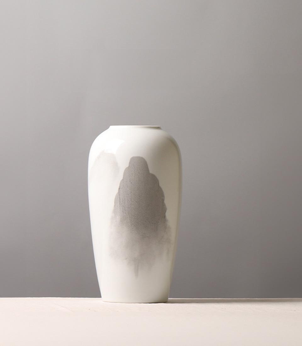 Minimalist white ceramic vase with abstract grey mountain landscape design