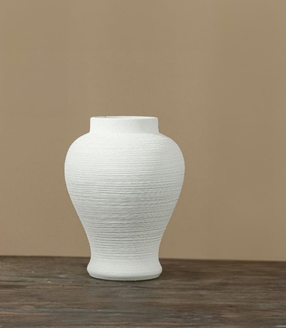 White ceramic vase with horizontal ribbed texture and rounded body, perfect for luxury gifting