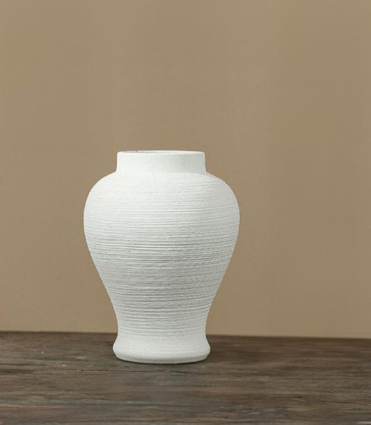 White ceramic vase with horizontal ribbed texture and rounded body, perfect for luxury gifting