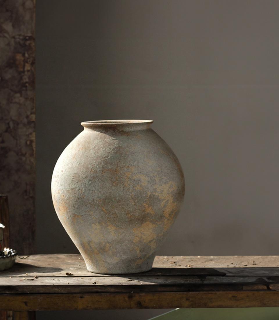 Vintage ceramic vase with grey-green glaze and rustic brown accents, handcrafted for luxury gift hampers