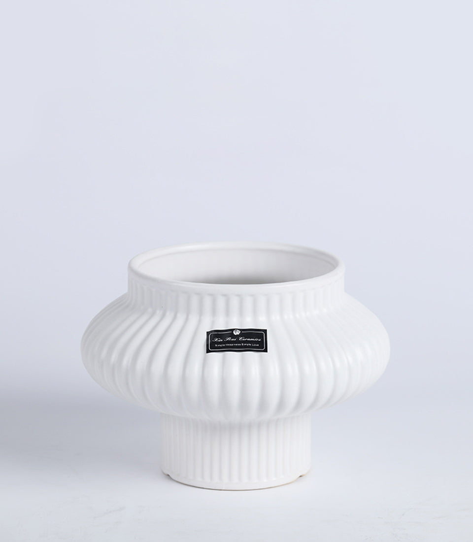 White ceramic fluted vase with rounded pumpkin shape, modern minimalist design for home décor or gifting
