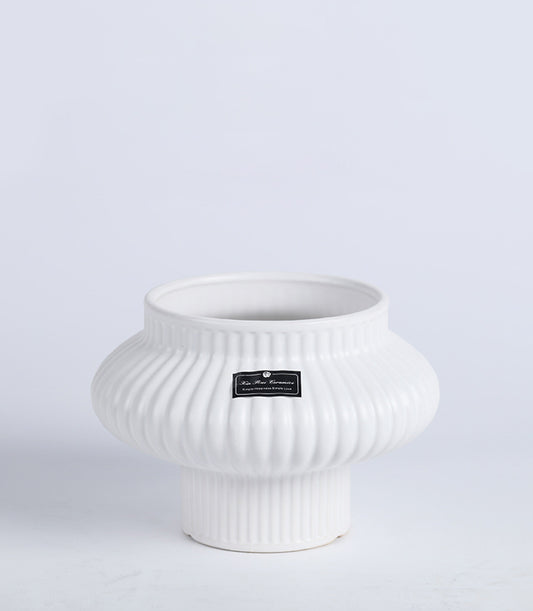 White ceramic fluted vase with rounded pumpkin shape, modern minimalist design for home décor or gifting