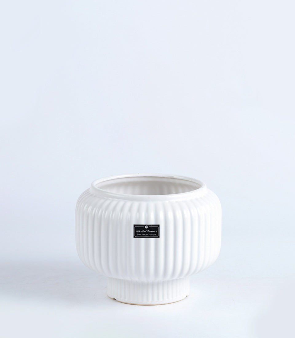 White ceramic vase with ribbed pearl texture and modern rounded form