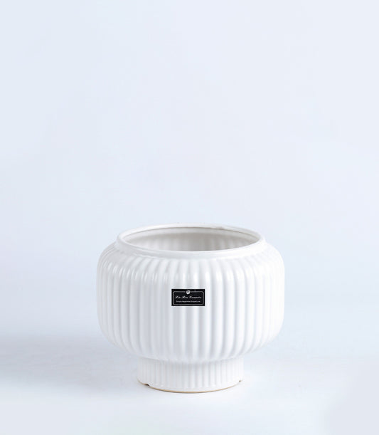 White ceramic vase with ribbed pearl texture and modern rounded form