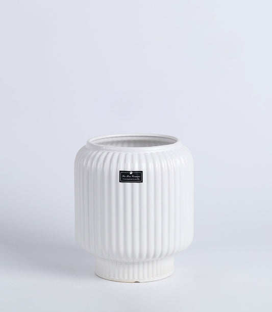 White ribbed ceramic vase with textured cylindrical body and flared base