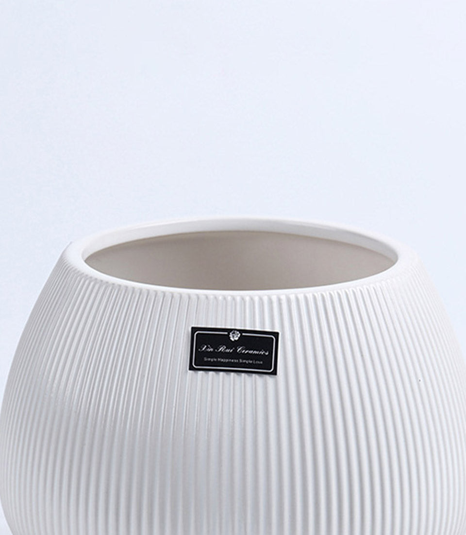 White ribbed ceramic vase with rounded body, artisan handcrafted vessel for fresh flowers and home décor