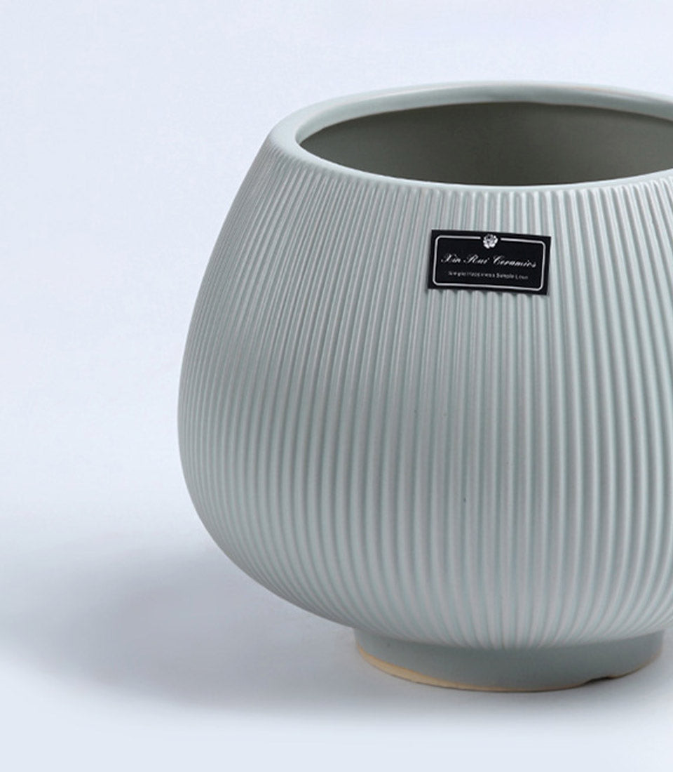 Light grey ceramic vase with textured ribbed surface and rounded bulbous form, ideal for fresh flowers or standalone display