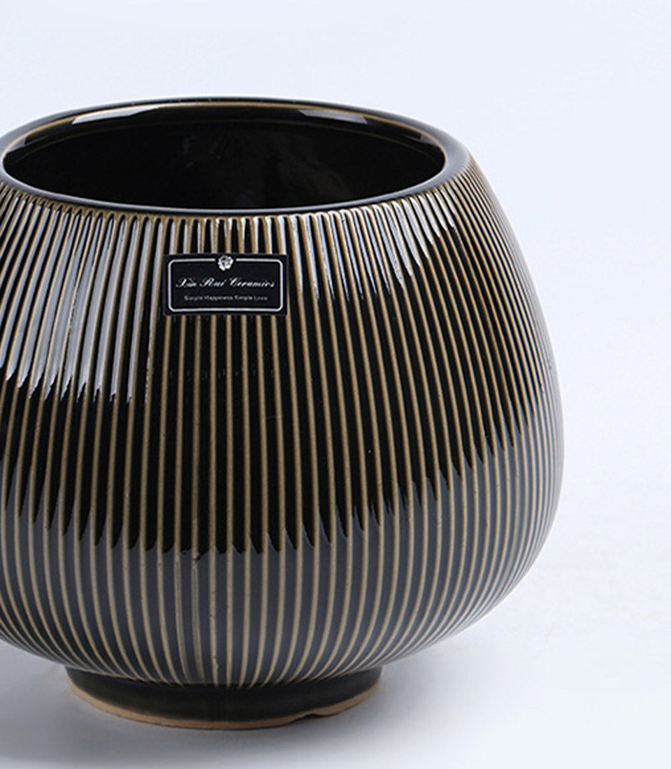 Black ceramic vase with gold vertical ribbed stripes, modern luxury home decor accent