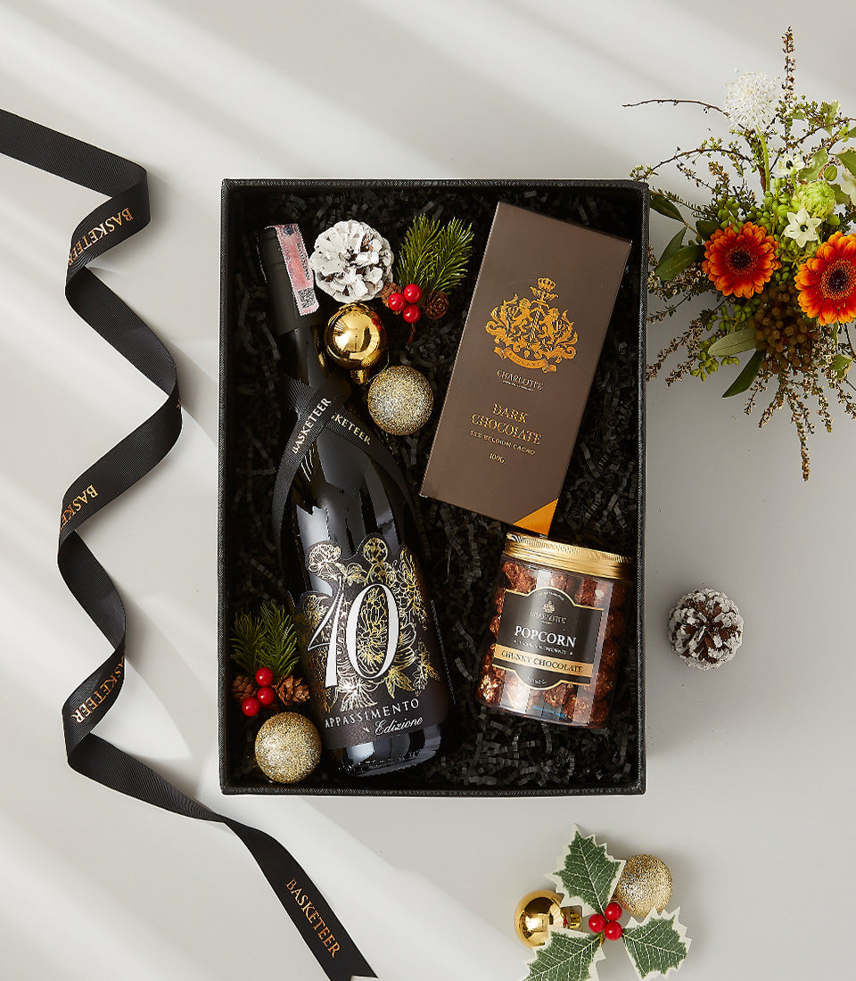 Premium wine gift box with 40 Appassimento red wine, artisan chocolate, and gourmet treats in festive black packaging