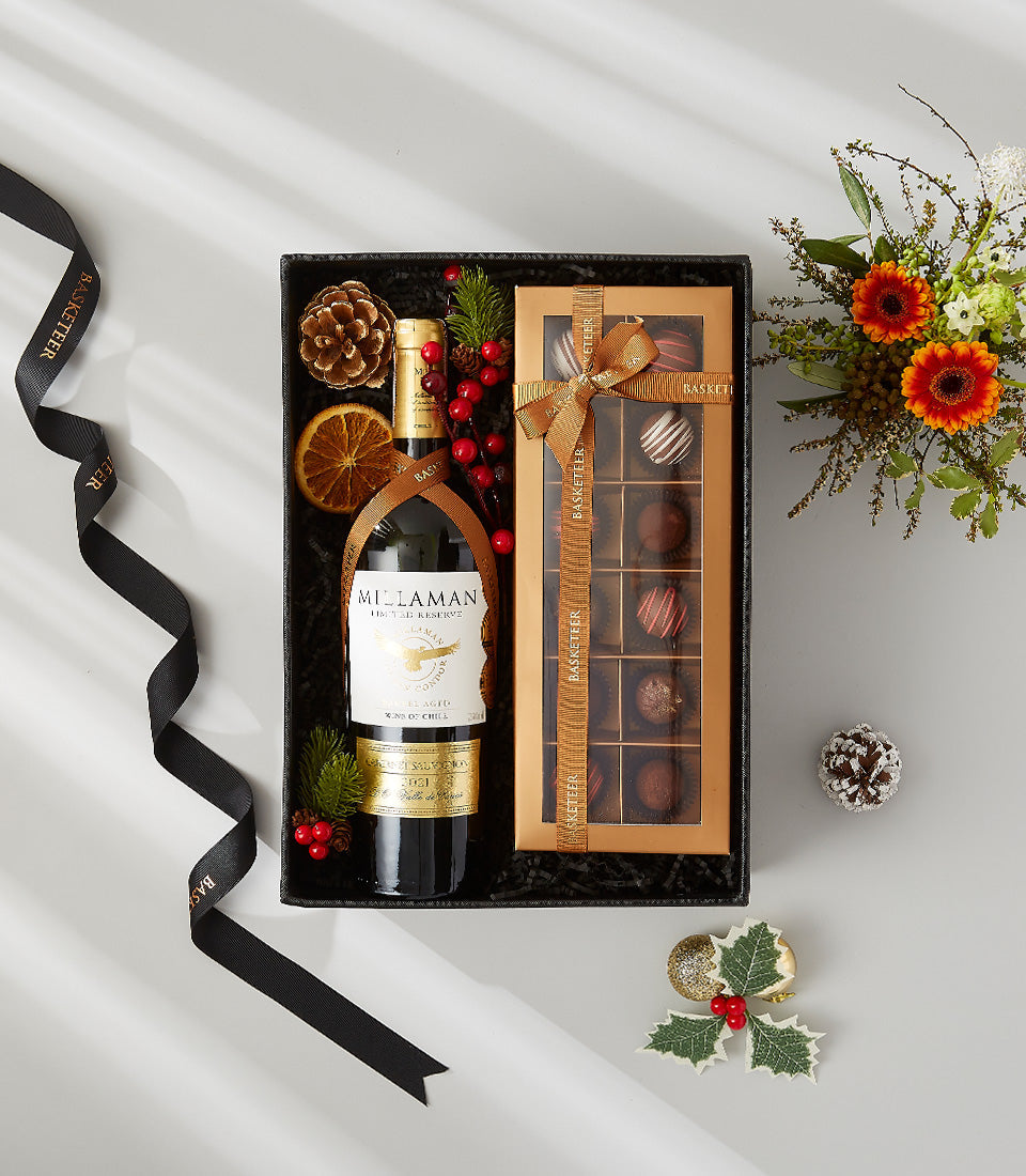 Red wine and chocolate gift set with festive dried fruit and berries in luxury black box
