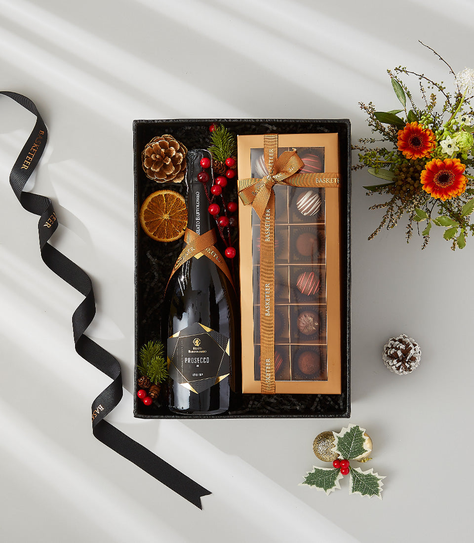 Prosecco sparkling wine and chocolates luxury gift set with gold ribbons, black gift box, and festive florals