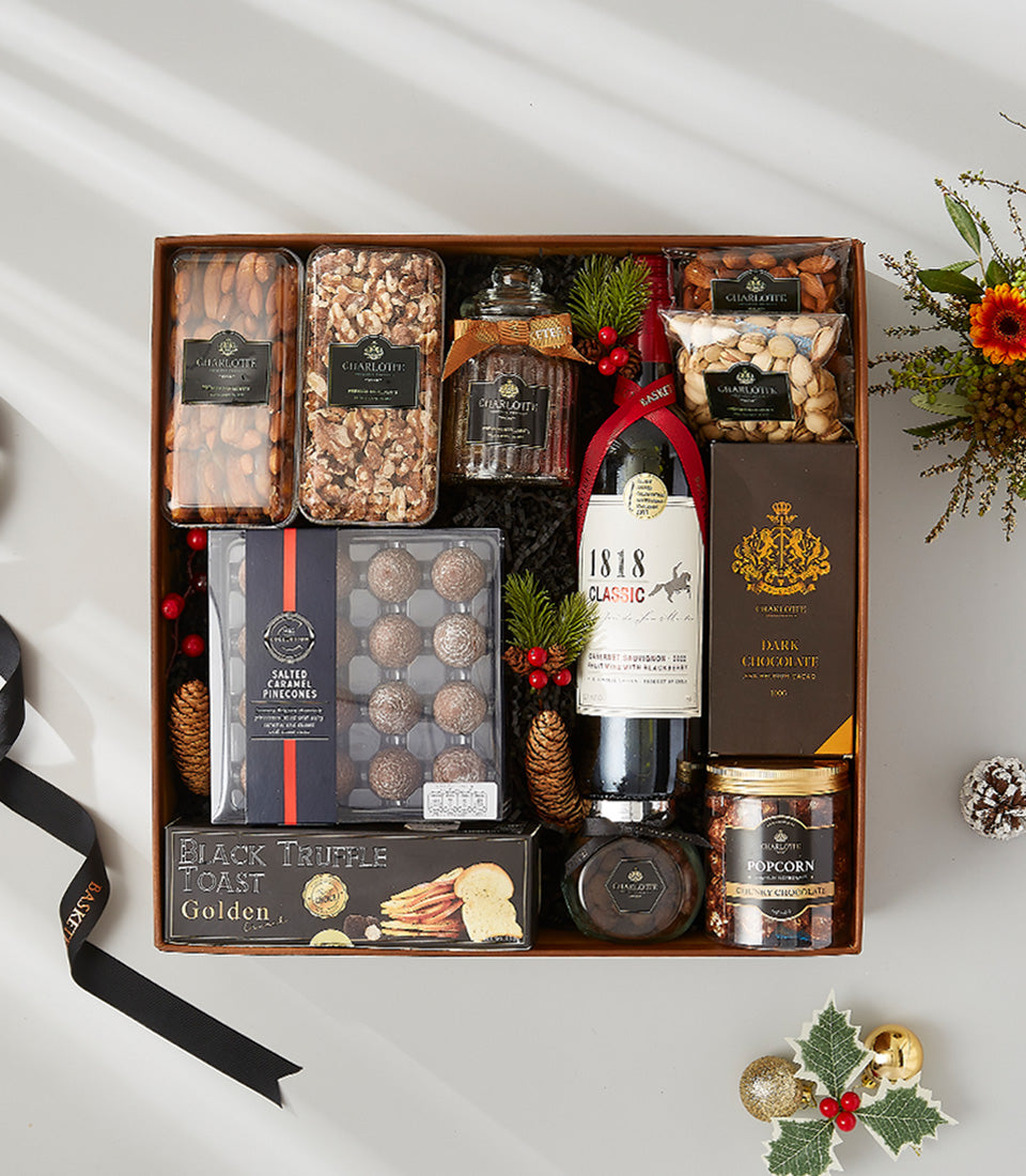 Premium festive gift basket with 1818 Classic red wine, gourmet nuts, chocolate, and artisan spreads