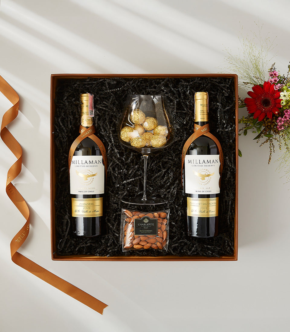 Premium red wine gift set with chocolates and almonds in wooden box, luxury wine lover present