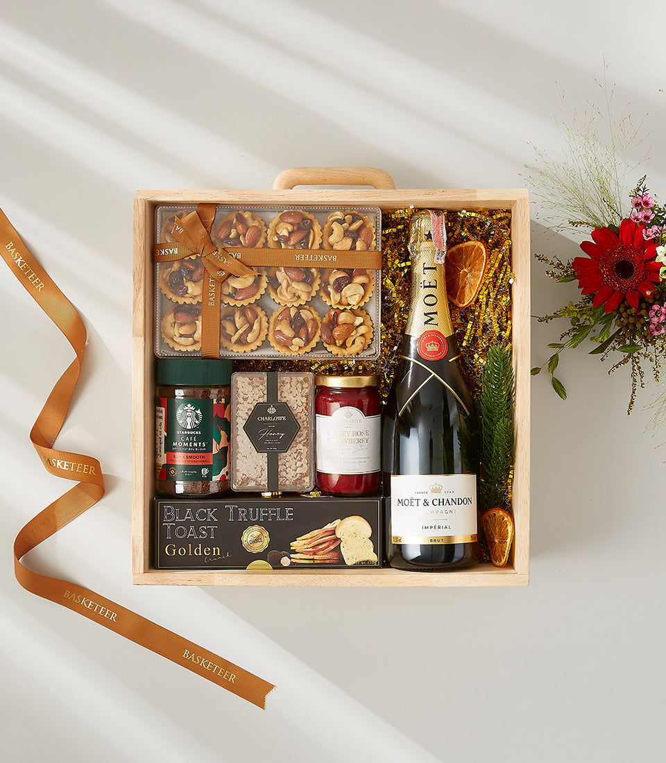Luxury wooden crate gift hamper with Moët champagne, gourmet treats, and fresh flowers