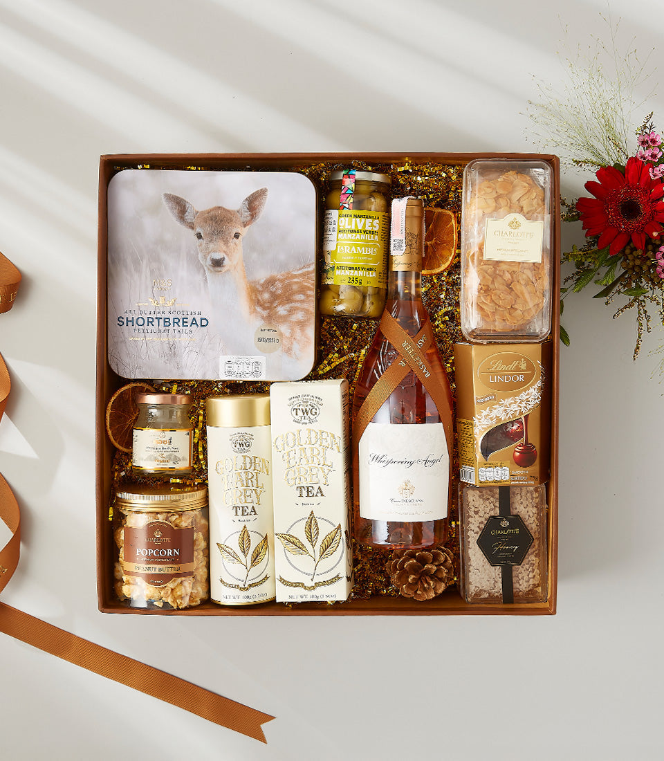 Rosé wine gift box with gourmet treats, shortbread, olives, chocolates, and TWG tea in luxury hamper