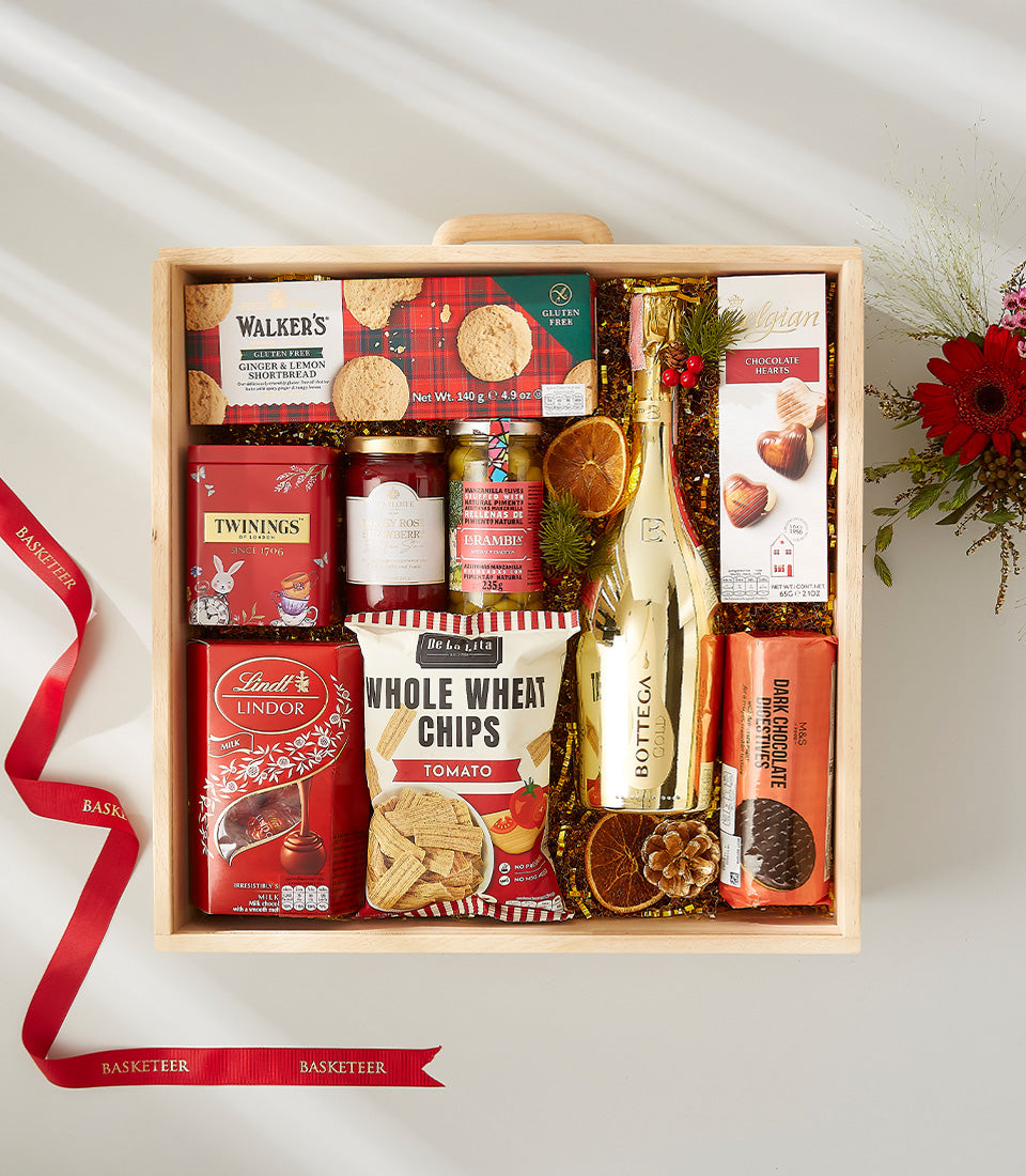 Wooden gift box with Bottega Gold sparkling wine, gourmet chocolates, shortbread, tea, and festive gold shredded paper