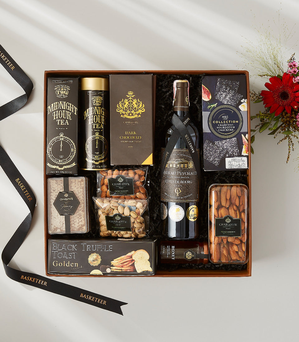 Chateau Peychaud red wine with dark chocolate, gourmet nuts, and crackers in luxury wooden gift hamper