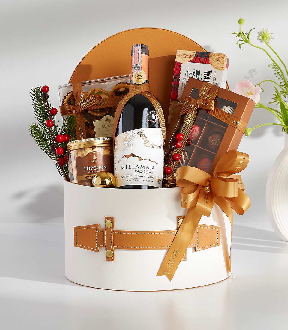 Elegant white hatbox gift with Cabernet Sauvignon wine, Charlotte gourmet popcorn, artisan chocolates, and festive trimmings