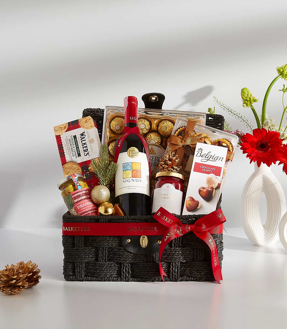 Premium wine gift basket with red wine, chocolates, and gourmet treats, festive holiday presentation