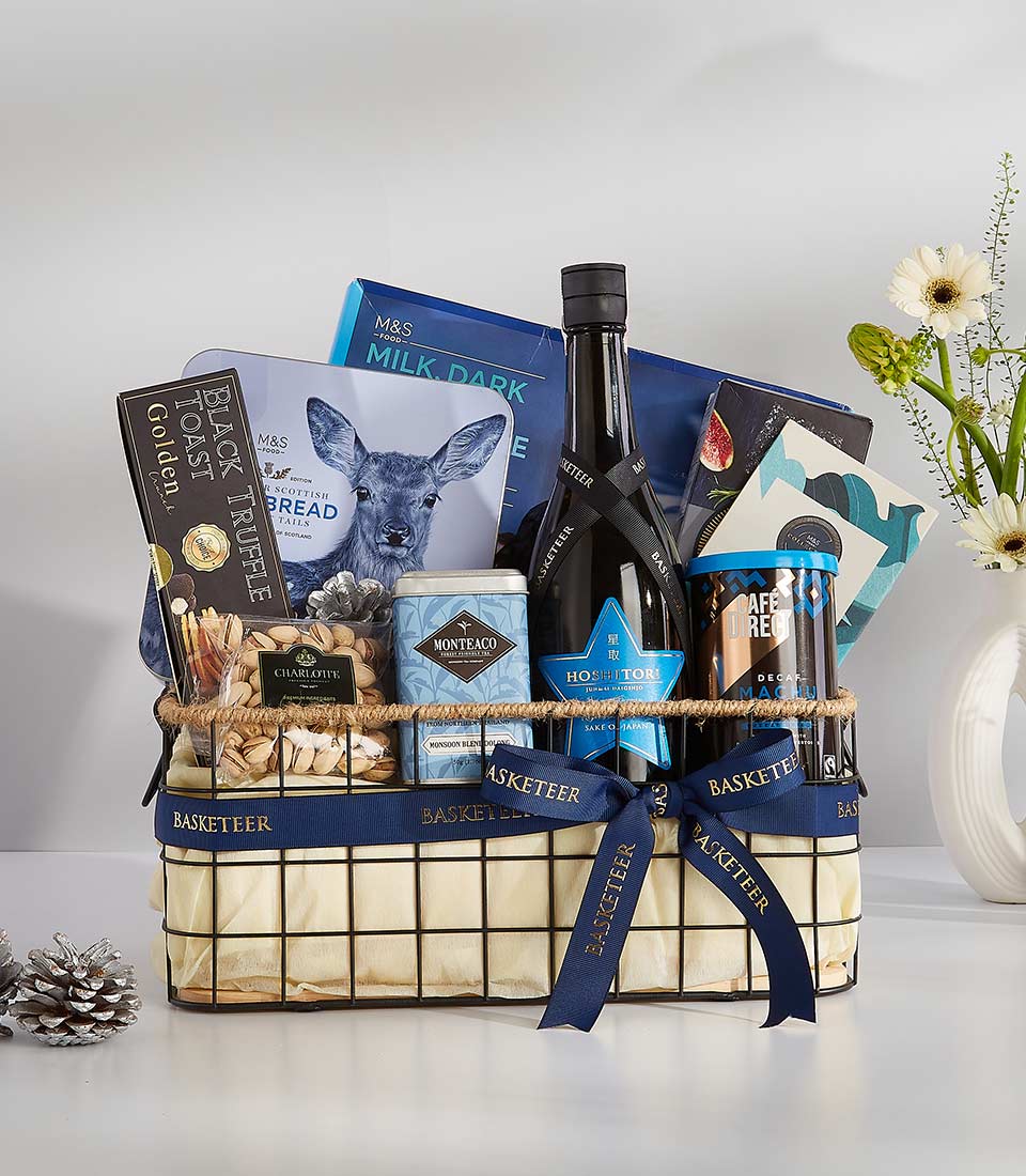 Midnight blue luxury wine gift basket with gourmet treats, black truffle crackers, pistachios, and artisan coffee
