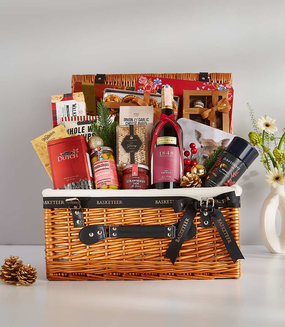 Premium wicker hamper with Shiraz wine, gourmet treats, and festive décor for luxury gifting