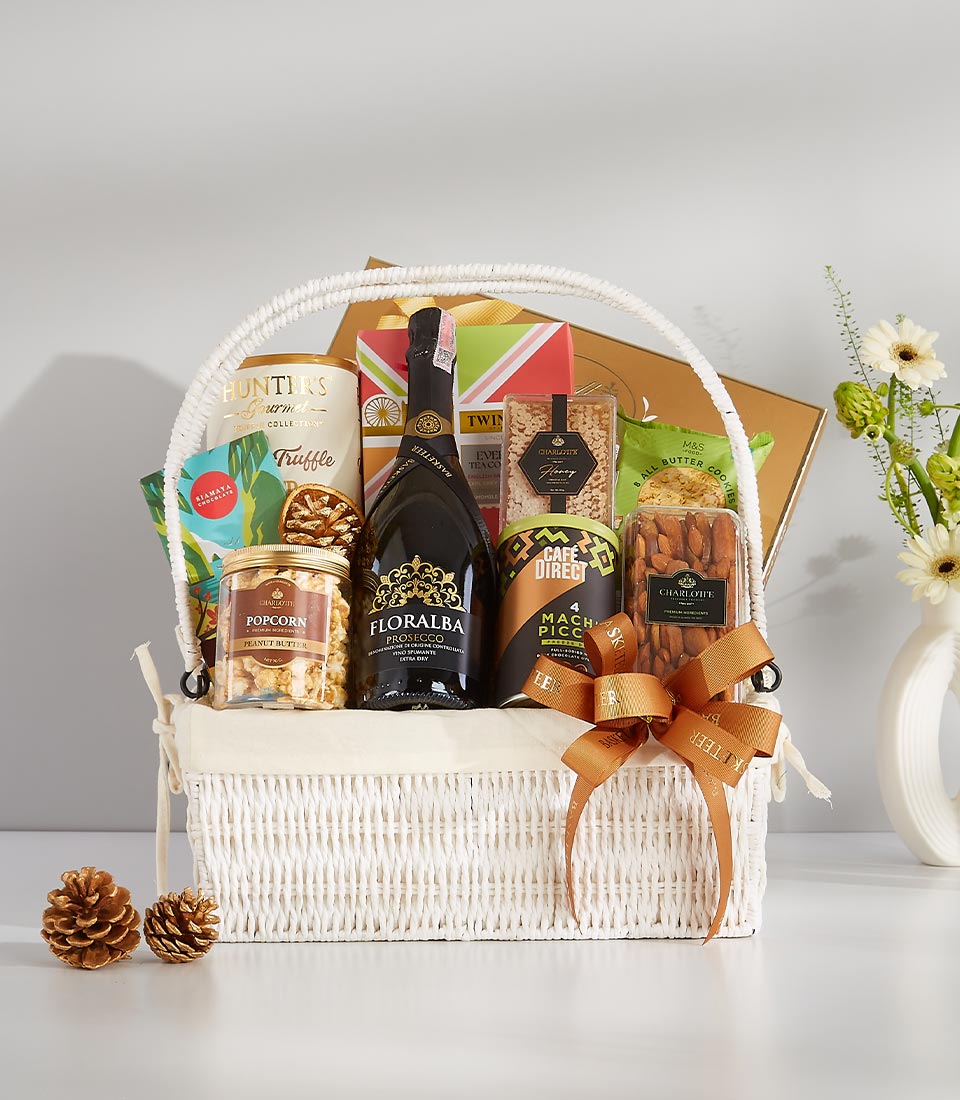 Premium wine gift basket with prosecco, gourmet snacks, and artisan treats in white wicker