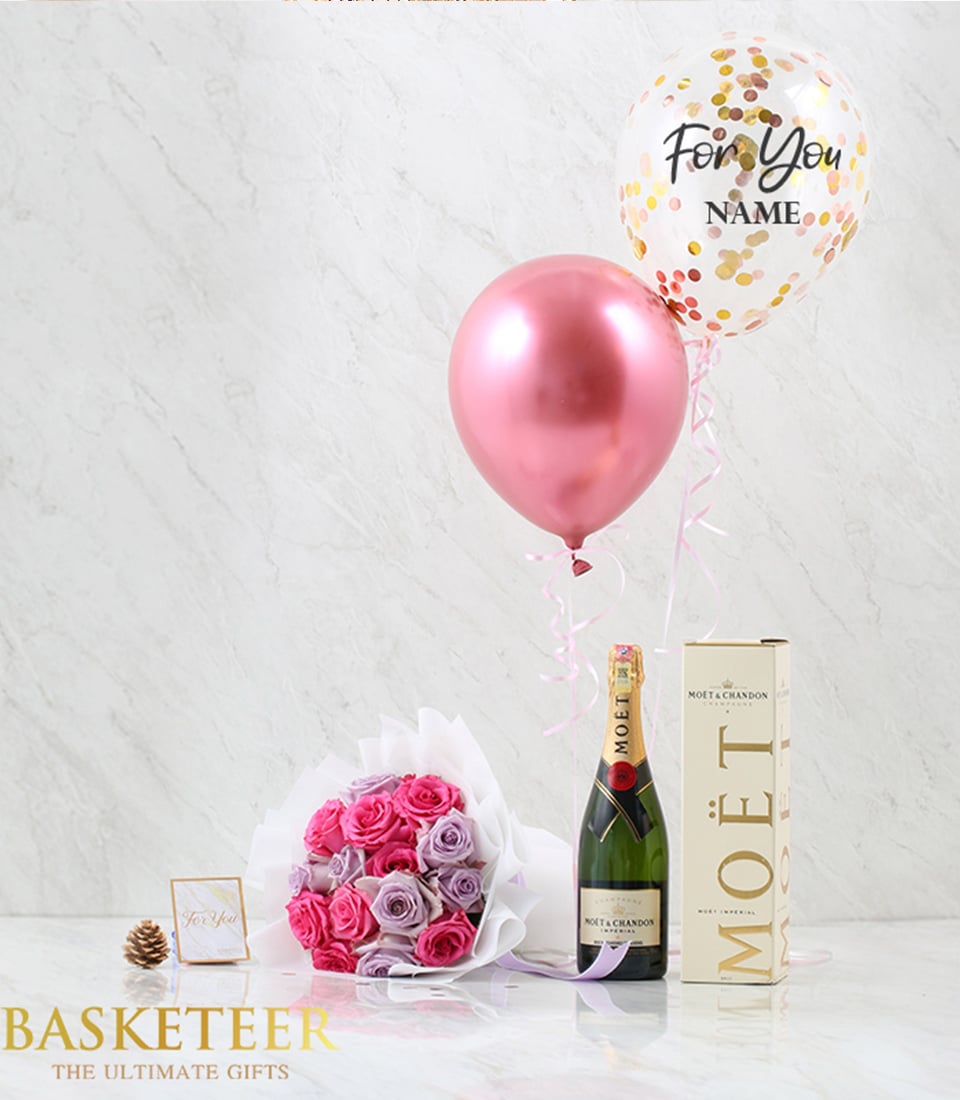 Luxury rose champagne gift set with pink and lavender roses, champagne bottle, and celebratory balloons